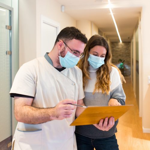 Nurse explaining notes to female patient in health center