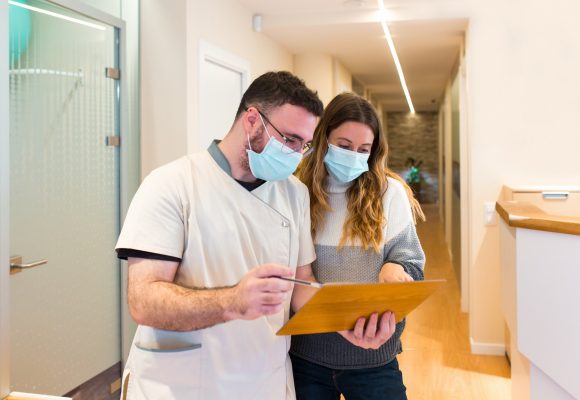 Nurse explaining notes to female patient in health center