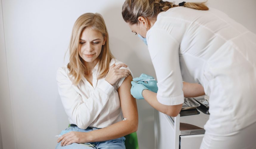 Woman doctor gives a vaccine to patients